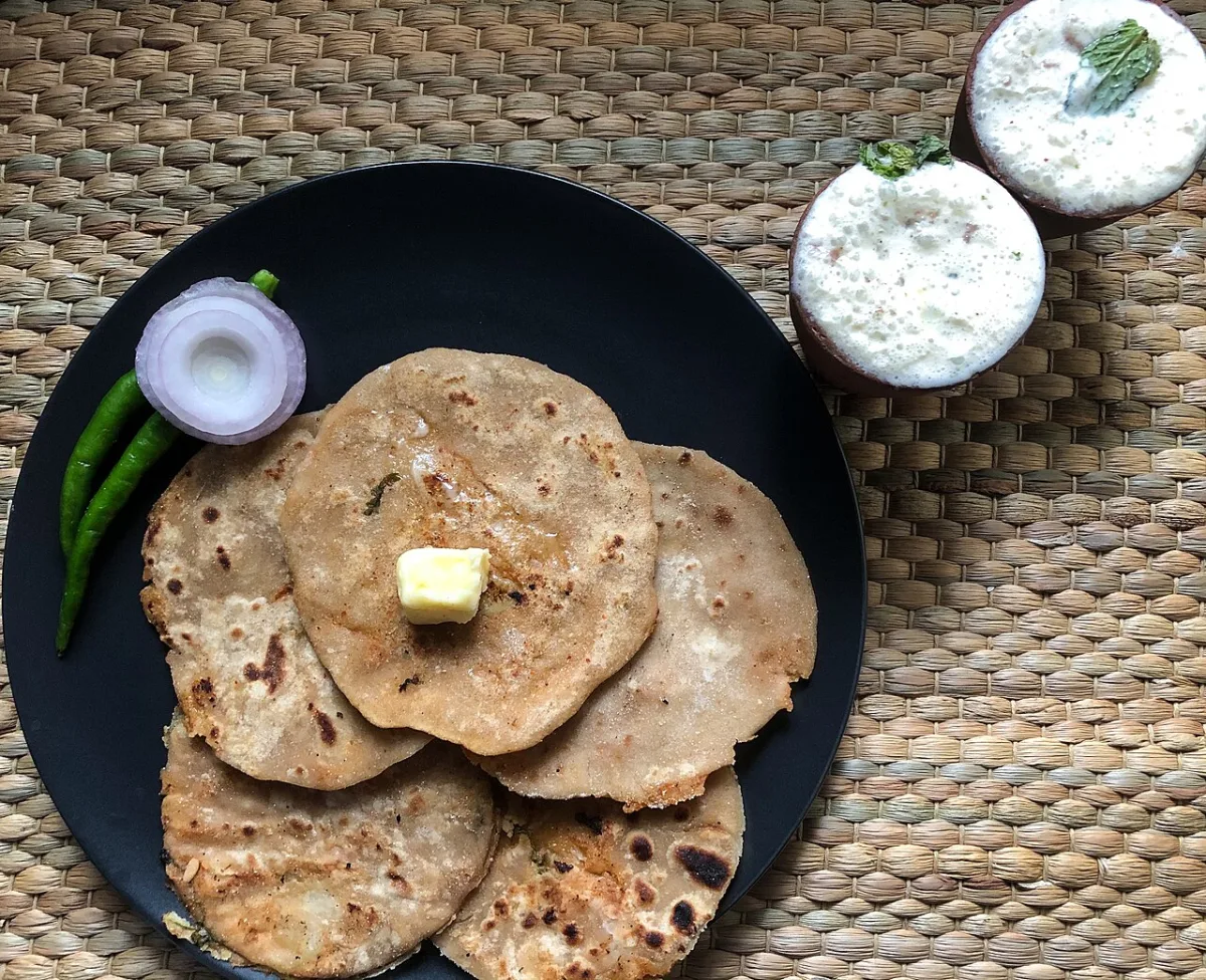 Aloo paratha with butter and a glass of lassi